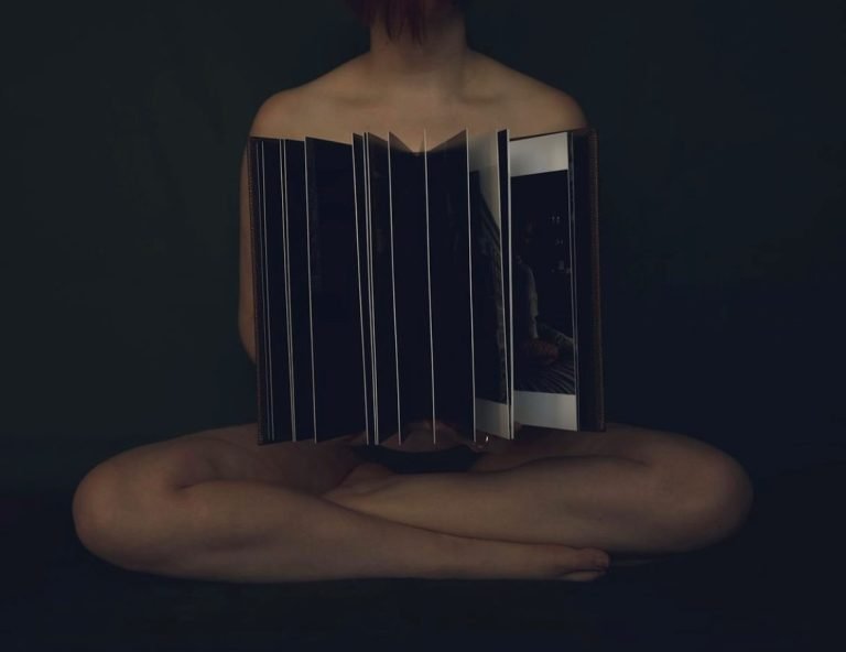 Woman holding her professionally printed handmade album in her hands